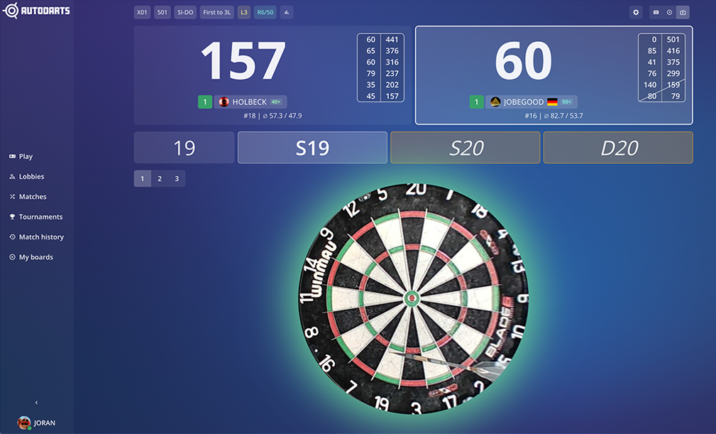 Autodarts scoreboard on a laptop next to a dartboard