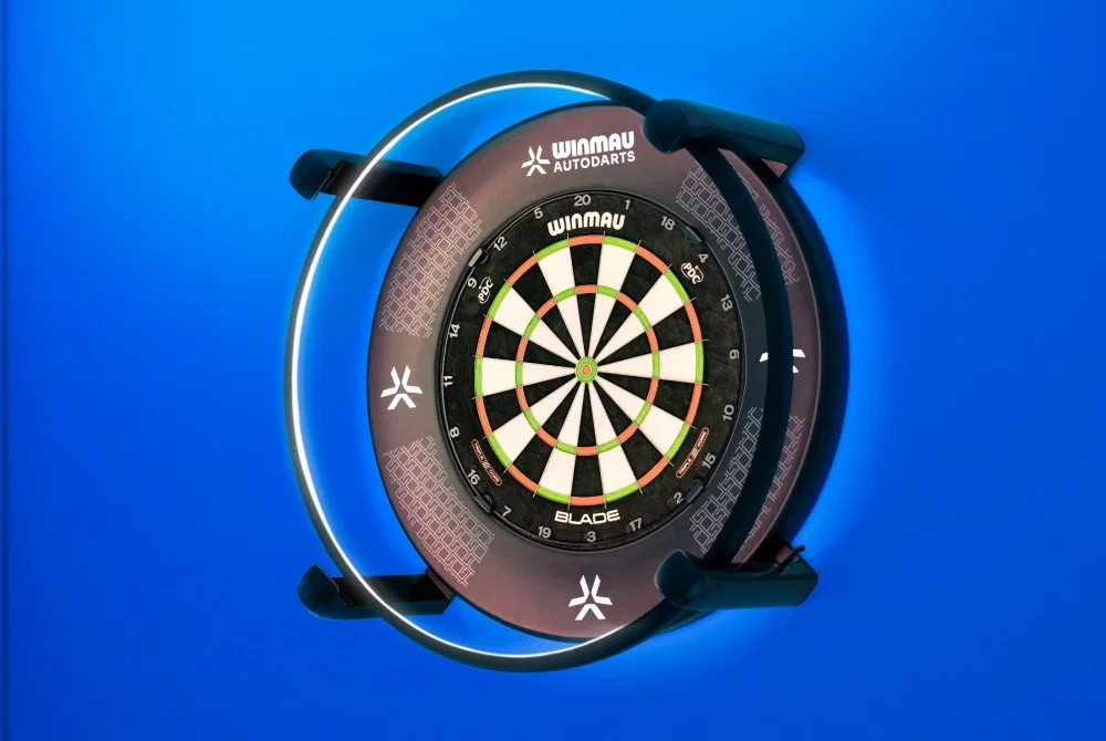 The Autodarts X camera and lighting ring fitted around a bristle dartboard